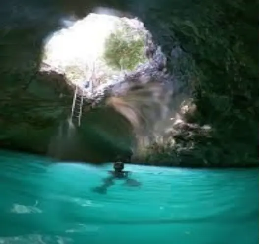 Swimmers enjoying the turquoise Blue Hole in Jamaica
