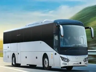 Large white passenger bus in the Jamare Tours fleet